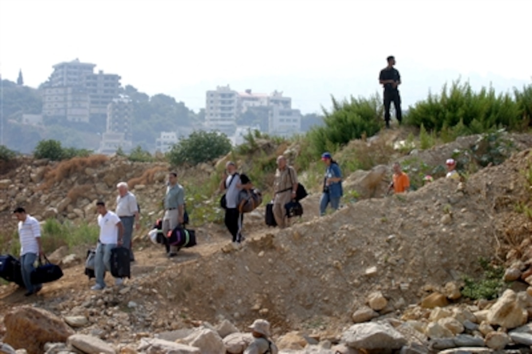 American citizens departing from Beirut, Lebanon, make their way to a waiting U.S. Navy landing craft utility vessel for transport to the amphibious transport dock USS Nashville, July 21, 2006. At the request of the U.S. Ambassador to Lebanon and at the direction of the U.S. Defense Secretary, the United States Central Command and elements of Task Force 59 are assisting with the departure of U.S. citizens from Lebanon. 