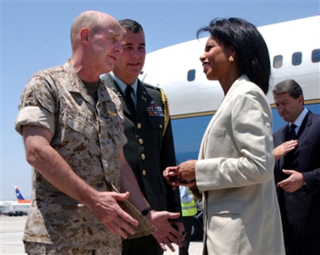 Secretary of State Condoleezza Rice speaks with U.S. Marine Corps Brig. Gen. Carl Jensen (left), commander of Task Force 59, and U.S. Army Lt. Col. Tom Mooney, defense attaché to the American Embassy in Cyprus, upon her arrival in Larnaca, Cyprus, July 24, 2006. 