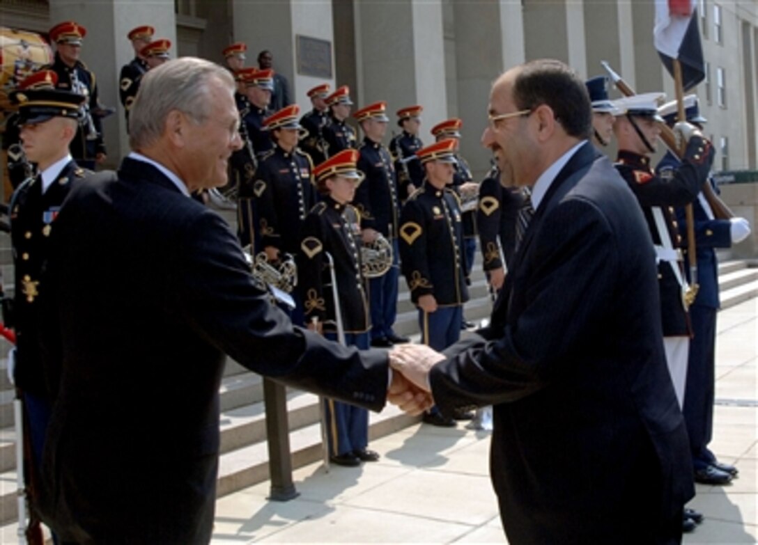 Secretary of Defense Donald H. Rumsfeld welcomes Prime Minister of Iraq Noori Al- Maliki as he arrives at the Pentagon to discuss issues of mutual interests, July 25, 2006. 