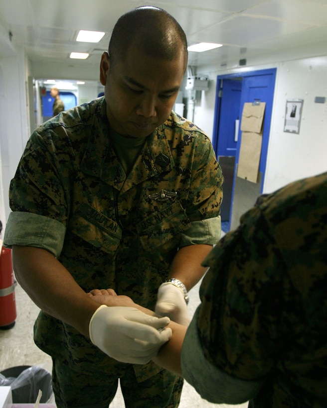 ABOARD USS BOXER (July 26, 2006) -- Hospital Corpsman 1st Class John C. Jucutan, assistant medical planner for the 15th Marine Expeditionary Unit administers a Purified Protein Derivative (PPD) skin test to a Marine during Composite Unit Training Exercise (COMPTUEX). Marines and Sailors of the 15th MEU recieve a series of vaccinations to help prevent viruses and diseases that are common in foreign countries that the 15th MEU may encounter during deployment. (Official USMC photo by Cpl. Scott L. Eberle) (Released)