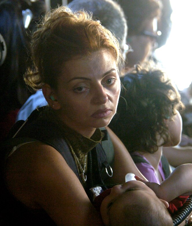OVER LEBANON (AFPN) -- Carole Souaidan holds her infant son while she is airlifted out of Beirut, Lebanon by a MH-53M Pave Low helicopter from the 352nd Special Operations Group, July 24. The group, out of Royal Air Force Mildenhall, England, deployed to Cyprus to help with the transportation of American citizens from Lebanon. (U.S. Air Force photo/Senior Airman Brian Ferguson)