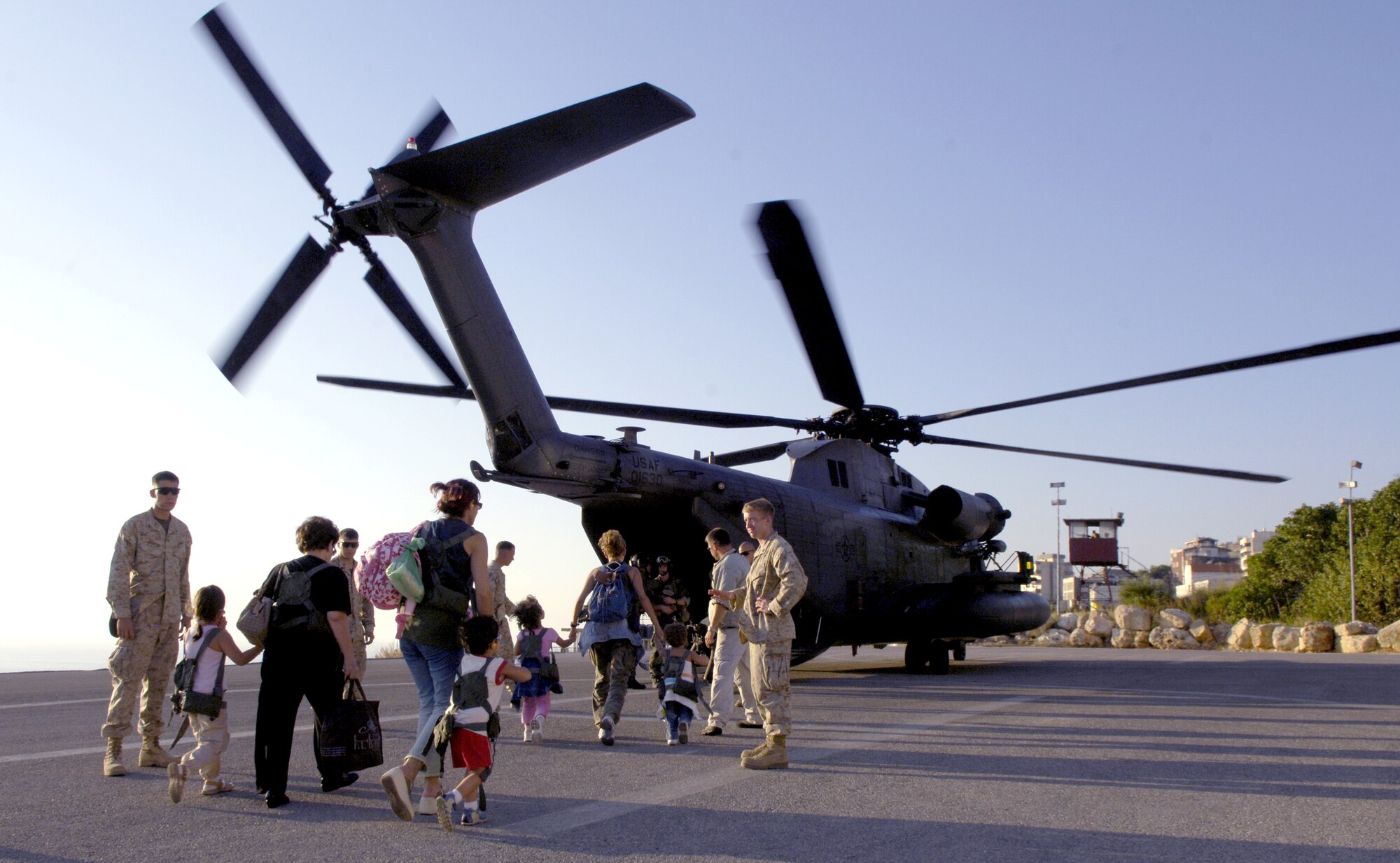 BEIRUT, Lebanon (AFPN) -- U.S. citizens board an MH-53M Pave Low helicopter here July 24. The helicopter is part of the 352nd Special Operations Group at Royal Air Force Mildenhall, England. (U.S. Air Force photo/Senior Airman Brian Ferguson)