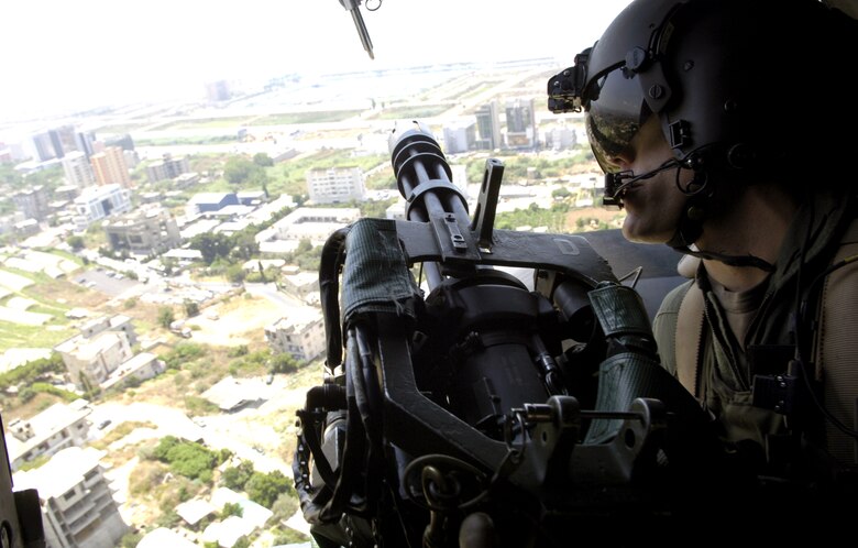 BEIRUT, Lebanon (AFPN) -- Master Sgt. Danny Leick checks the right side of an MH-53M Pave Low helicopter over the city here July 24. Sergeant Leick is a flight engineer with the 352nd Special Operations Group at Royal Air Force Mildenhall, England, and is deployed to help with the transportation of American citizens from Lebanon. (U.S. Air Force photo/Senior Airman Brian Ferguson)