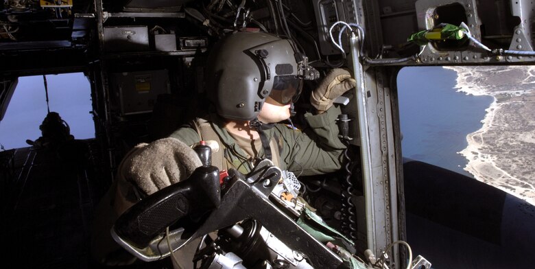 CYPRUS (AFPN) -- Tech. Sgt. John Stott checks the left side of a MH-53M Pave Low helicopter in flight July 24. Sergeant Stott is an aerial gunner with the 352nd Special Operations Group at Royal Air Force Mildenhall, England, and is deployed here to help with the transportation of American citizens from Lebanon. (U.S. Air Force photo/Senior Airman Brian Ferguson)