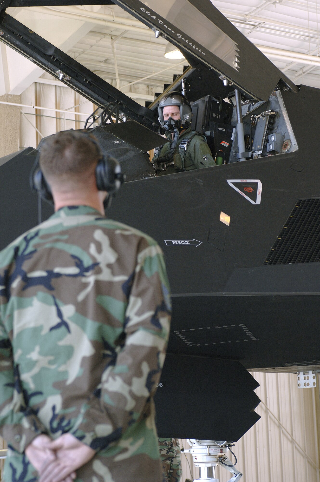 Col. John Forsythe makes final checks with Staff Sgt. Kasey Lynch before departing on a special flight July 25th at Holloman Air Force Base New Mexico.  The flight was commemorating 250,000 hours of operation by F-117 Nighthawks.  Colonel Forsythe is the 49th Operations Group commander.  Sergeant Lynch is a crew chief assigned to the 49th Fighter Wing.  (U.S. Air Force photo/Airman John D. Strong II) 