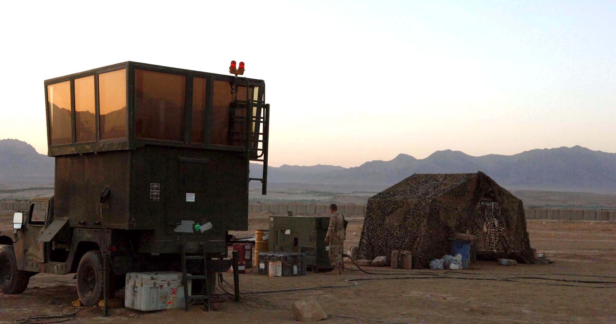 Airman 1st Class Juan Felanpena checks the mobile air traffic control center generator before the sun sets July 10 at Tarin Kowt, Afghanistan. Airman Felanpena, a power production specialist, is deployed to Forward Operating Base Martello with an 11-person air traffic control team at the request of the Army. (U.S. Air Force photo/Master Sgt. Orville F. Desjarlais Jr.) 