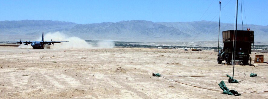 A C-130 Hercules from Bagram Airfield, Afghanistan, lands on the dirt runway at Tarin Kowt, Afghanistan, on July 10. An air traffic control team of 11 Airmen is deployed to Forward Operating Base Martello at the request of the Army to control the skies over this war zone. (U.S. Air Force photo/Master Sgt. Orville F. Desjarlais Jr.) 