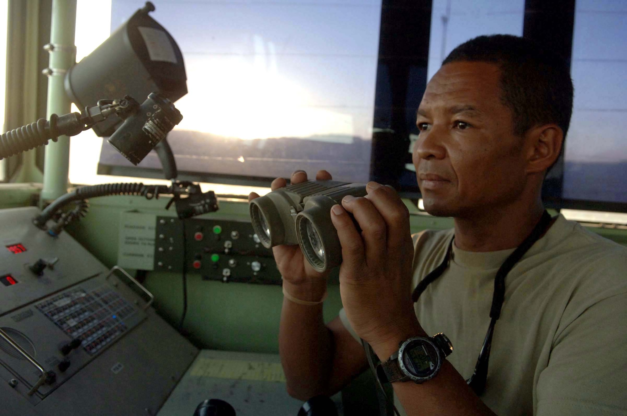 Tech. Sgt. Toshiya Jones monitors aircraft as they park on the narrow, dirt airstrip at Tarin Kowt, Afghanistan, on July 10. Sergeant Jones is an air traffic controller deployed from Tinker Air Force Base, Okla. (U.S. Air Force photo/Master Sgt. Orville F. Desjarlais Jr.)