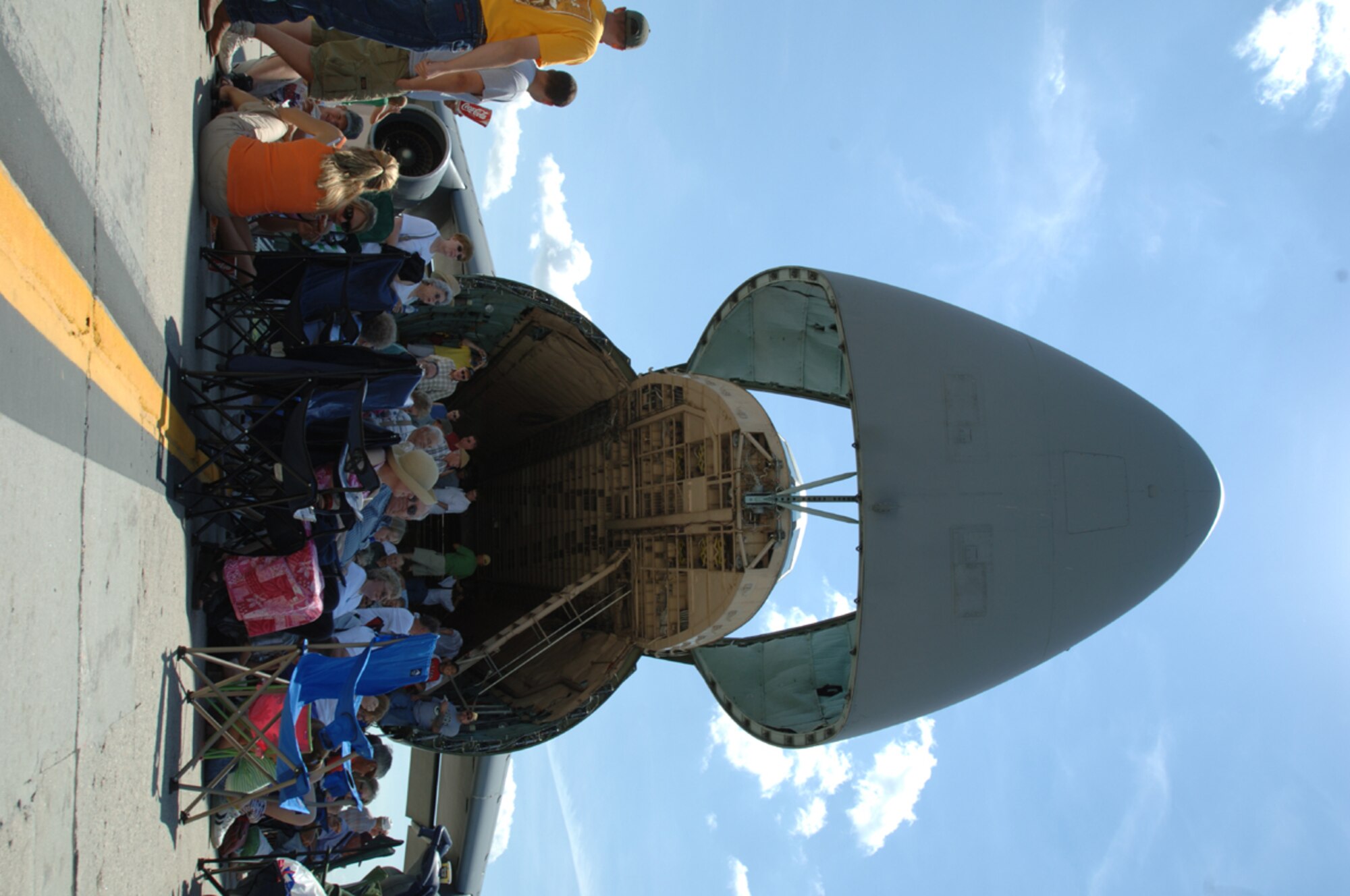 Spectators crowd around a C-5B Galaxy for some shad on the Bravo Ramp during the air show.