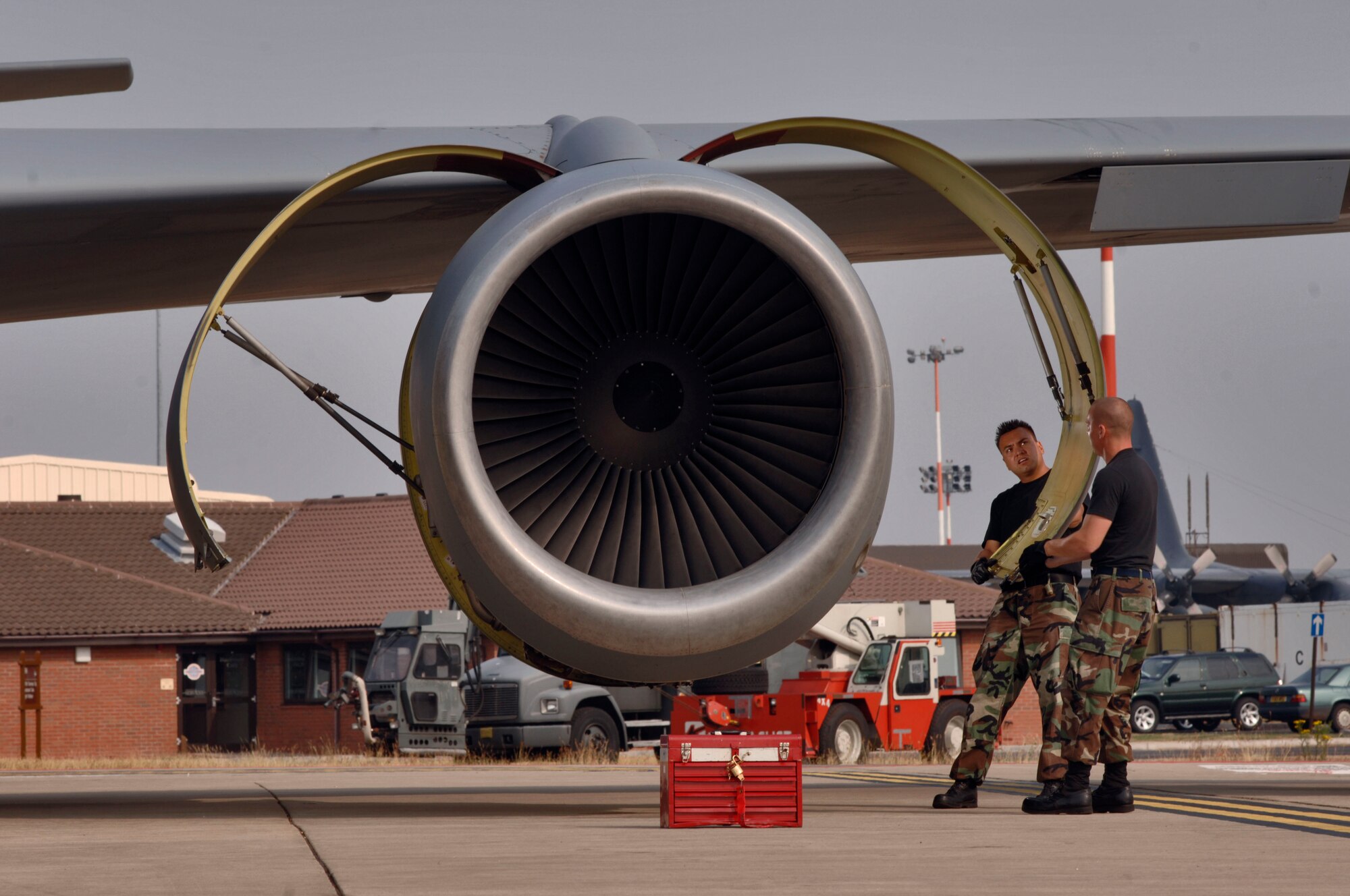 Airman 1st Class Brian Sloppy (right) and Senior Airman Jimmy Aguilar open the turbofan engine cowling of a KC-135 Stratotanker at Royal Air Force Mildenhall, England, on July 26. The Airmen are crew chiefs with the 100th Aircraft Maintenance Squadron. They work 12-hour shifts to keep their fleet of 15 tankers flying. (U.S. Air Force photo/Master Sgt. Lance Cheung)