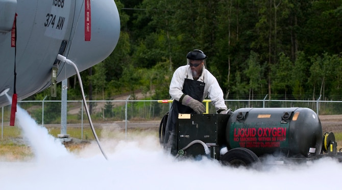 Senior Airman Sherman Roberts loads liquid oxygen on a C-130 Hercules at Elmendorf Air Force Base, Alaska, on July 25. Airman Roberts is with the 36th Aircraft Maintenance Unit at Yokota Air Base, Japan. The Yokota C-130s are in Alaska participating in the Pacific Air Forces exercise Cooperative Cope Thunder. (U.S. Air Force photo/Senior Airman Garrett Hothan)