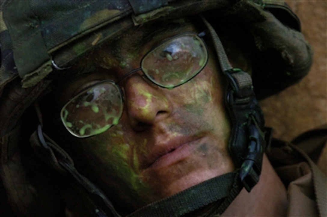 U.S. Marine Corps Pfc. Andrew Nadolski is covered with residue during a military operation in urban terrain exercise held at Schofield Barracks in Hawaii on July 23, 2006, as part of exercise Rim of the Pacific 2006. The exercise brings together military forces from Australia, Canada, Chile, Peru, Japan, the Republic of Korea, the United Kingdom, and the United States. 