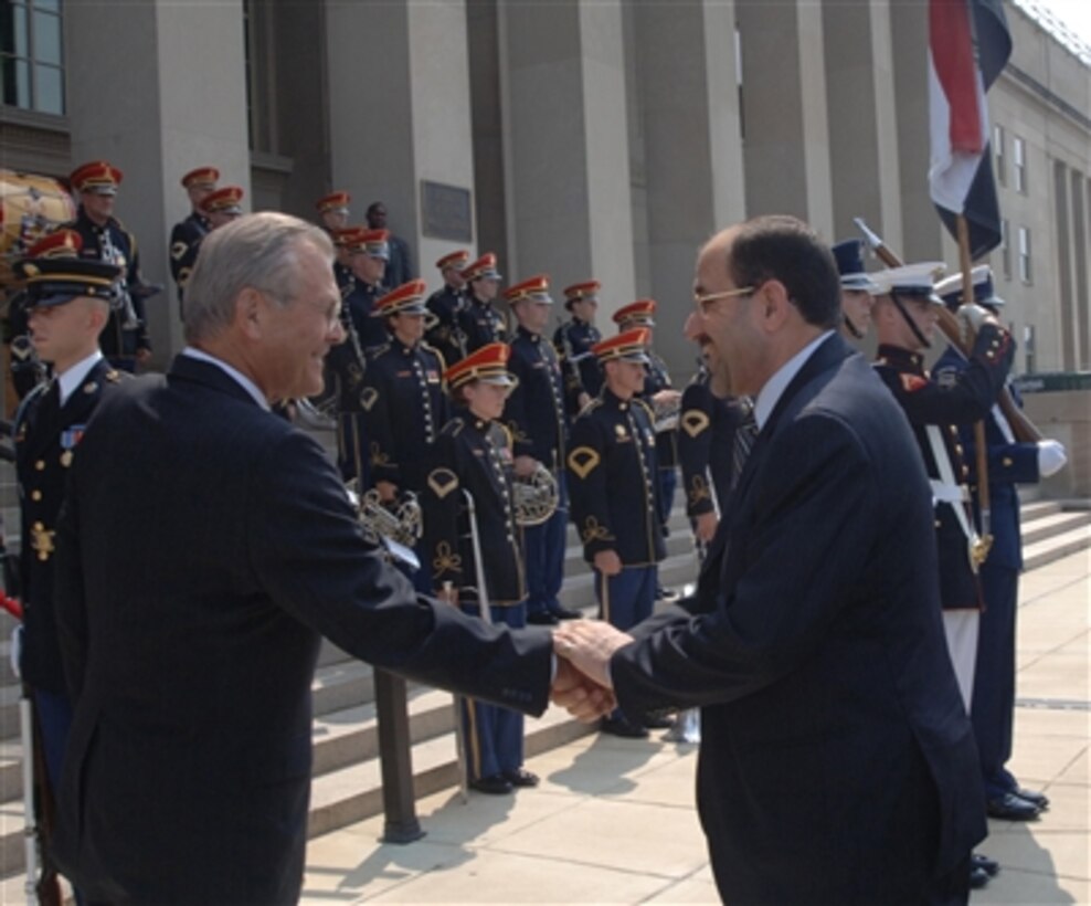 Secretary of Defense Donald H. Rumsfeld (left) welcomes Prime Minister of Iraq Nuri al-Maliki (right) as he arrives at the Pentagon July 25, 2006. Rumsfeld, Maliki and their senior staffs will meet to discuss defense issues of mutual interest. 