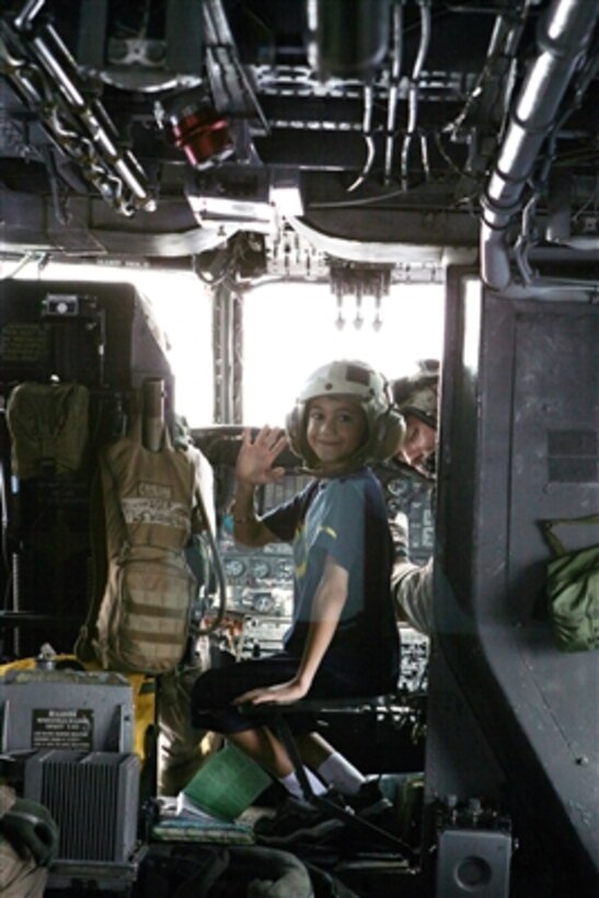 A young girl waves from inside of the cockpit of a U.S. Marine Corps CH-53E Super Stallion helicopter during a flight to Cyprus on July 20, 2006. At the request of the U.S. Ambassador to Lebanon and at the direction of the Secretary of Defense, the United States Central Command and elements of Task Force 59 are assisting with the departure of U.S. citizens from Lebanon. 