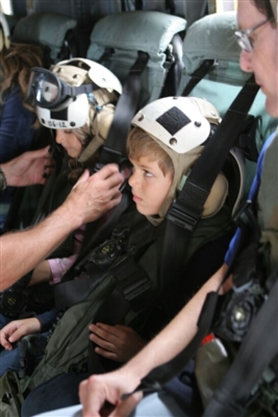 A young child watches as he is secured into his seat aboard a U.S. Marine Corps CH-53E Super Stallion helicopter in Beirut, Lebanon, for a flight to Cyprus on July 20, 2006. At the request of the U.S. Ambassador to Lebanon and at the direction of the Secretary of Defense, the United States Central Command and elements of Task Force 59 are assisting with the departure of U.S. citizens from Lebanon. 