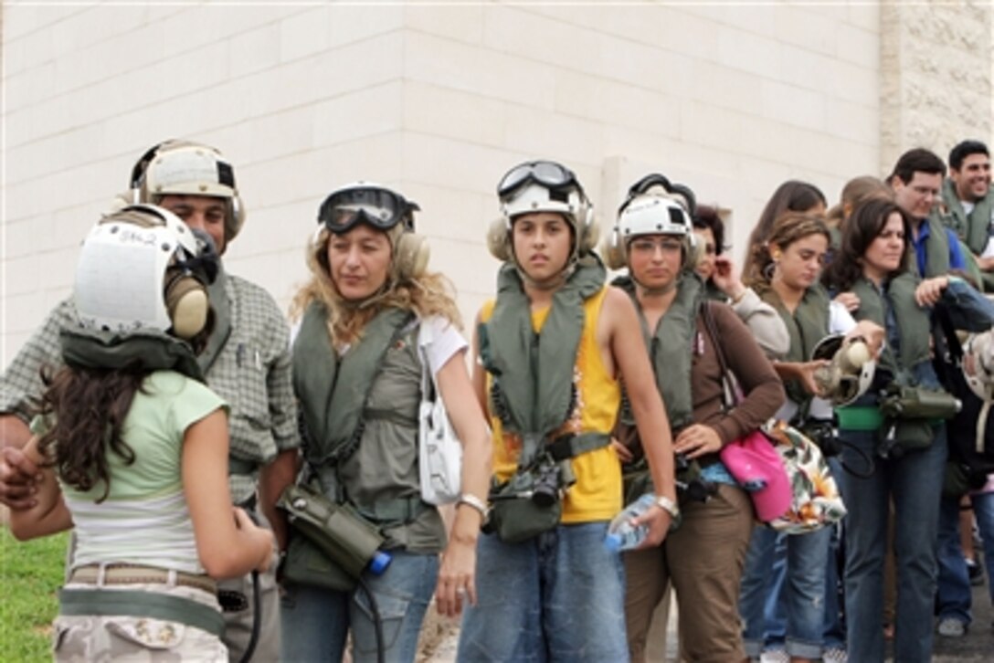 U.S. citizens put on their cranial helmets and life preservers as they wait to board a CH-53 Super Stallion helicopter at the U.S. Embassy in Beirut, Lebanon, for a flight to Cyprus on July 20, 2006. At the request of the U.S. Ambassador to Lebanon and at the direction of the Secretary of Defense, the United States Central Command and elements of Task Force 59 are assisting with the departure of U.S. citizens from Lebanon.
