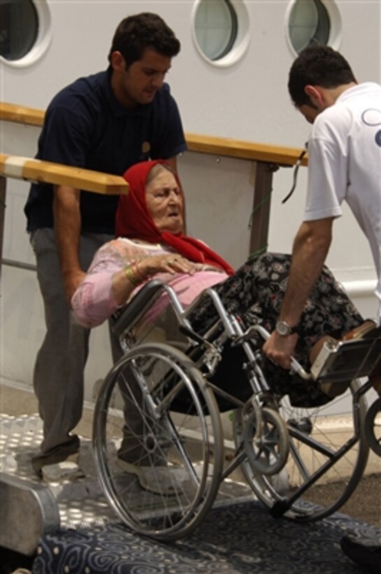 Crewmembers from the cruise ship Orient Queen assist a U.S. citizen as she boards the ship in Beirut, Lebanon, for transport to Cyprus on July 19, 2006. The ship, under contract with the U.S. government, is part of the larger U.S. military mission to assist U.S. citizens in their departure from Lebanon.