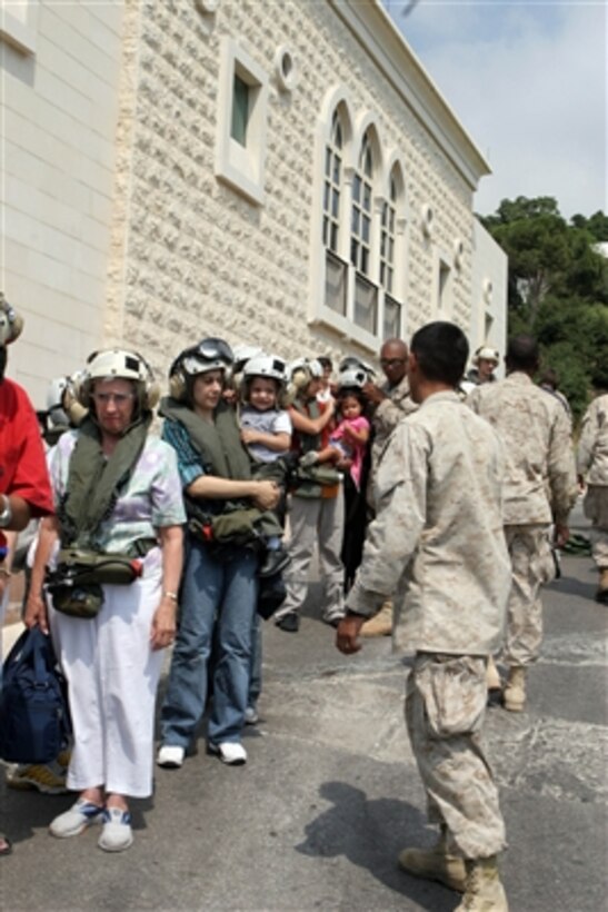 U.S. Marines help U.S. citizens as they wait to board a CH-53 Super Stallion helicopter at the U.S. Embassy in Beirut, Lebanon, for a flight to Cyprus on July 19, 2006. At the request of the U.S. Ambassador to Lebanon and at the direction of the Secretary of Defense, the United States Central Command and 24th Marine Expeditionary Unit are assisting with the departure of U.S. citizens from Lebanon. 