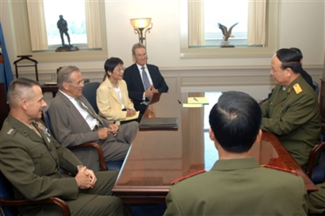 Secretary of Defense Donald H. Rumsfeld (second from left) sits down with Vice Chairman of the People's Republic of China Central Military Commission Gen. Guo Boxiong (right) for a bilateral meeting in Rumsfeld's Pentagon office on July 18, 2006. Chairman of the Joint Chiefs of Staff Gen. Peter Pace, U.S. Marine Corps, (left) and Assistant Secretary of Defense for International Security Affairs Peter W. Rodman (fourth from left) joined Rumsfeld in the meeting. 