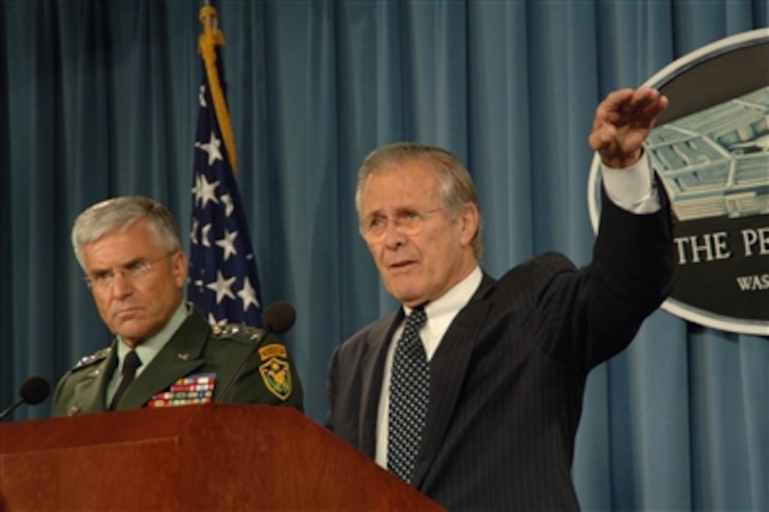 Secretary of Defense Donald H. Rumsfeld (right) gestures to make his point as he and Commanding General Multi-National Force- Iraq Gen. George W. Casey Jr., U.S. Army, conduct a Pentagon press briefing in Arlington, Va., on June 22, 2006.  Rumsfeld and Casey responded to questions from the press on the progress of the war on terrorism and gave an operational update. 