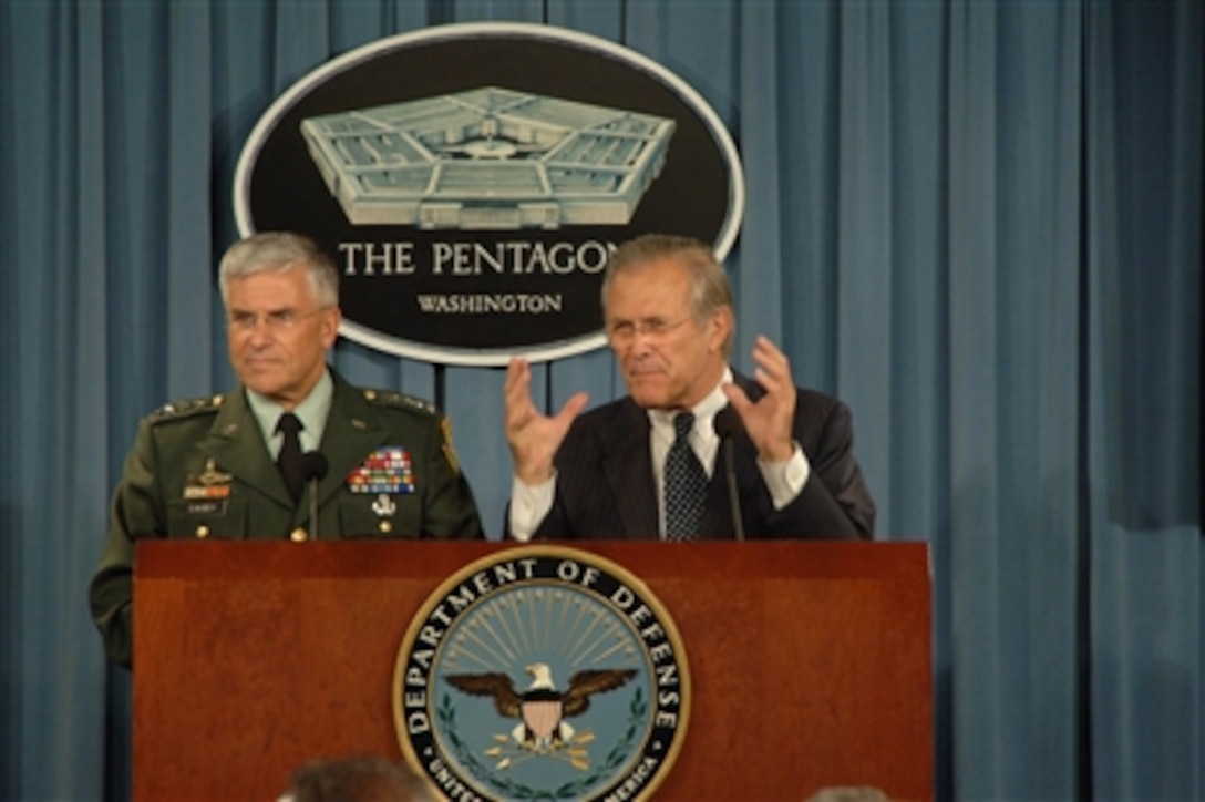 Secretary of Defense Donald H. Rumsfeld (right) gestures to make his point as he and Commanding General Multi-National Force- Iraq Gen. George W. Casey Jr., U.S. Army, conduct a Pentagon press briefing in Arlington, Va., on June 22, 2006.  Rumsfeld and Casey responded to questions from the press on the progress of the war on terrorism and gave an operational update.  