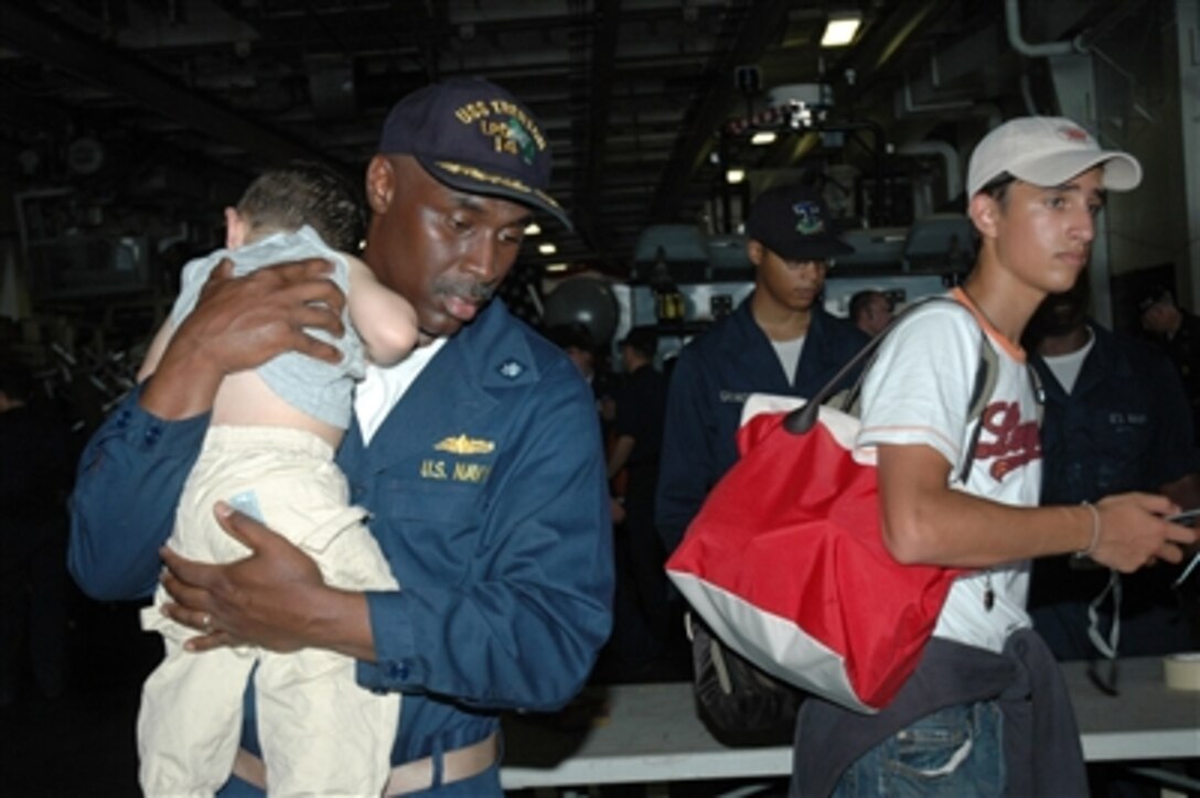 U.S. Navy sailors aboard the amphibious assault ship USS Iwo Jima (LHD 7) assist American citizens arriving from Beirut, Lebanon, on July 22, 2006. At the request of the U.S. Ambassador to Lebanon and at the direction of the Secretary of Defense, the United States Central Command and elements of Task Force 59 are assisting with the departure of U.S. citizens from Lebanon. 