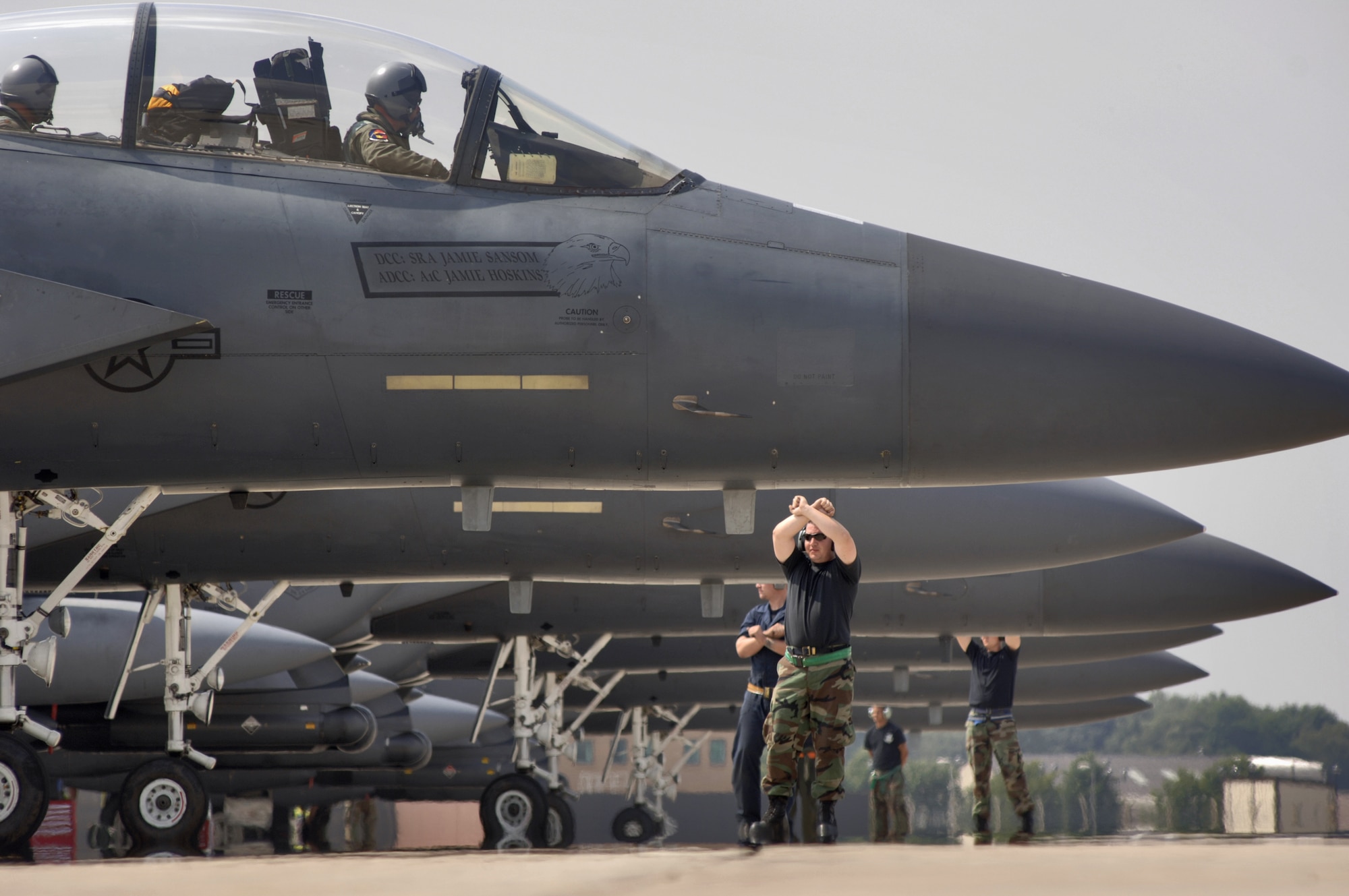 Crew chiefs marshal F-15E Strike Eagles to their parking spaces at Royal Air Force Base Lakenheath, England, on Friday, July 28. The 492nd Fighter Squadron jets were returning home from a two-week deployment to Graf-Isnatievo Air Base, Bulgaria, where they took part in exercise Immediate Response, which began July 17. Airmen from the 48th Fighter Wing provided support at the joint, trilateral exercise with the Bulgarian and Romanian militaries and U.S. Soldiers. The Airmen practiced ground attack and air-to-air tactics. (U.S. Air Force photo/Master Sgt. Lance Cheung)