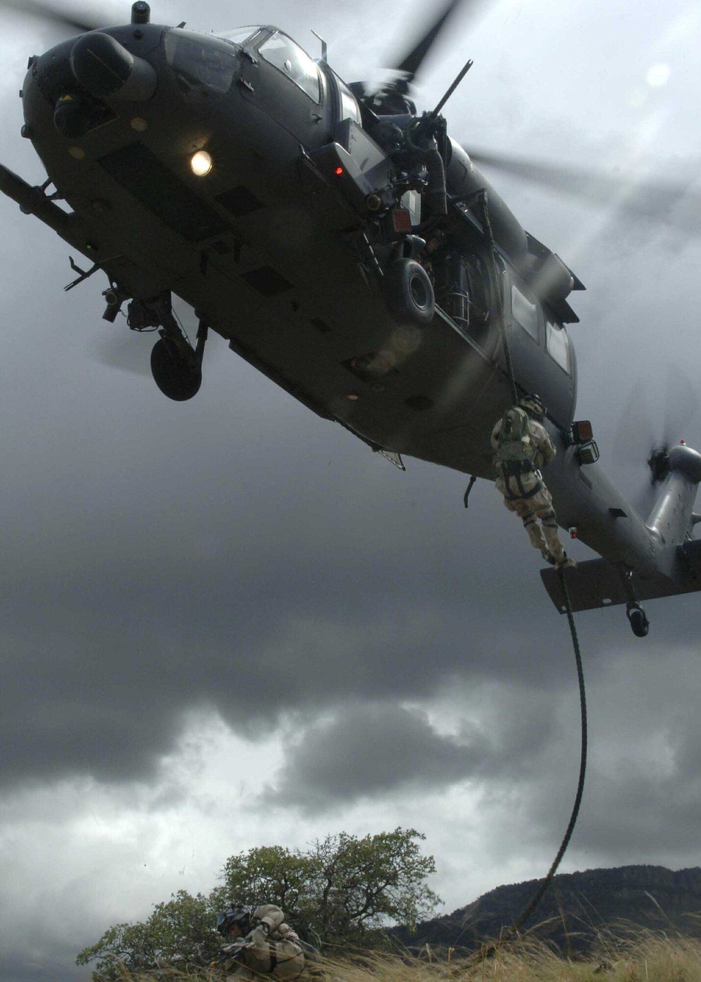 Pararescuemen from the 58th Rescue Squadron fast rope out of a HH-60 Pavehawk to reach a simulated crash site July 27 as part of a mass casualty scenario in exercise Angel Thunder. The mass casualty scenario involved two CH-47 Chinook helicopters crashing. Once on the ground, pararescuemen triaged survivors and relocated them to a casualty collection point. They were then flown to Davis-Monthan Air Force Base to a simulated level 2/3 medical facility. This part of exercise Angel Thunder involved the 48th, 58th, 66th, 79th and 305th Rescue Squadrons as well as air support from the 358th Fighter Squadron. (U.S. Air Force photo/Senior Airman Christina D. Ponte)