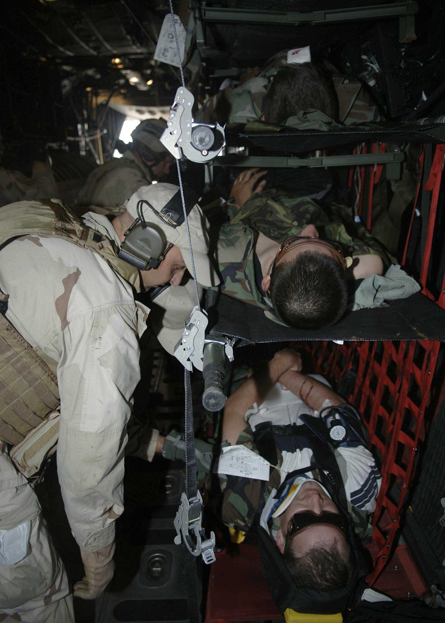 Master Sergeant Michael Arena secures simulated mass casualty survivors July 27 into a HC-130 as part of exercise Angel Thunder. They were then flown to Davis-Monthan Air Force Base to a simulated level 2/3 medical facility. This part of exercise Angel Thunder involved the 48th, 58th, 66th, 79th and 305th Rescue Squadrons as well as air support from the 358th Fighter Squadron. Sergeant Arena is with the 48th Rescue Squadron. (U.S. Air Force photo/Senior Airman Christina D. Ponte)