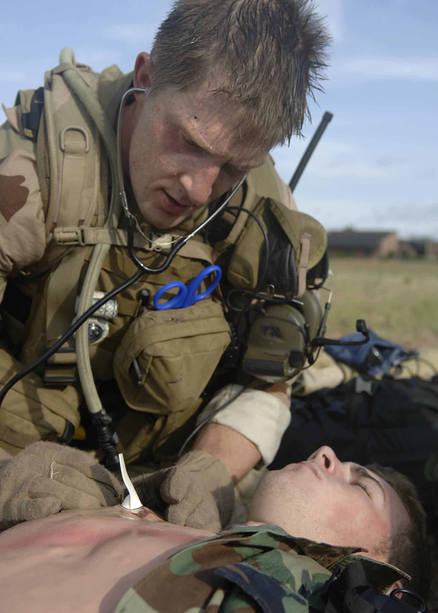 Senior Airman Troy Thompson checks the vital signs of a simulated wounded patient as part of a mass casualty scenario during exercise Angel Thunder July 27. The mass casualty scenario involved two CH-47 Chinook helicopters crashing. Once on the ground, pararescuemen triaged survivors and relocated them to a casualty collection point. They were then flown to Davis-Monthan Air Force Base to a simulated level 2/3 medical facility. This part of exercise Angel Thunder involved the 48th, 58th, 66th, 79th and 305th Rescue Squadrons as well as air support from the 358th Fighter Squadron. (U.S. Air Force photo/Senior Airman Christina D. Ponte)