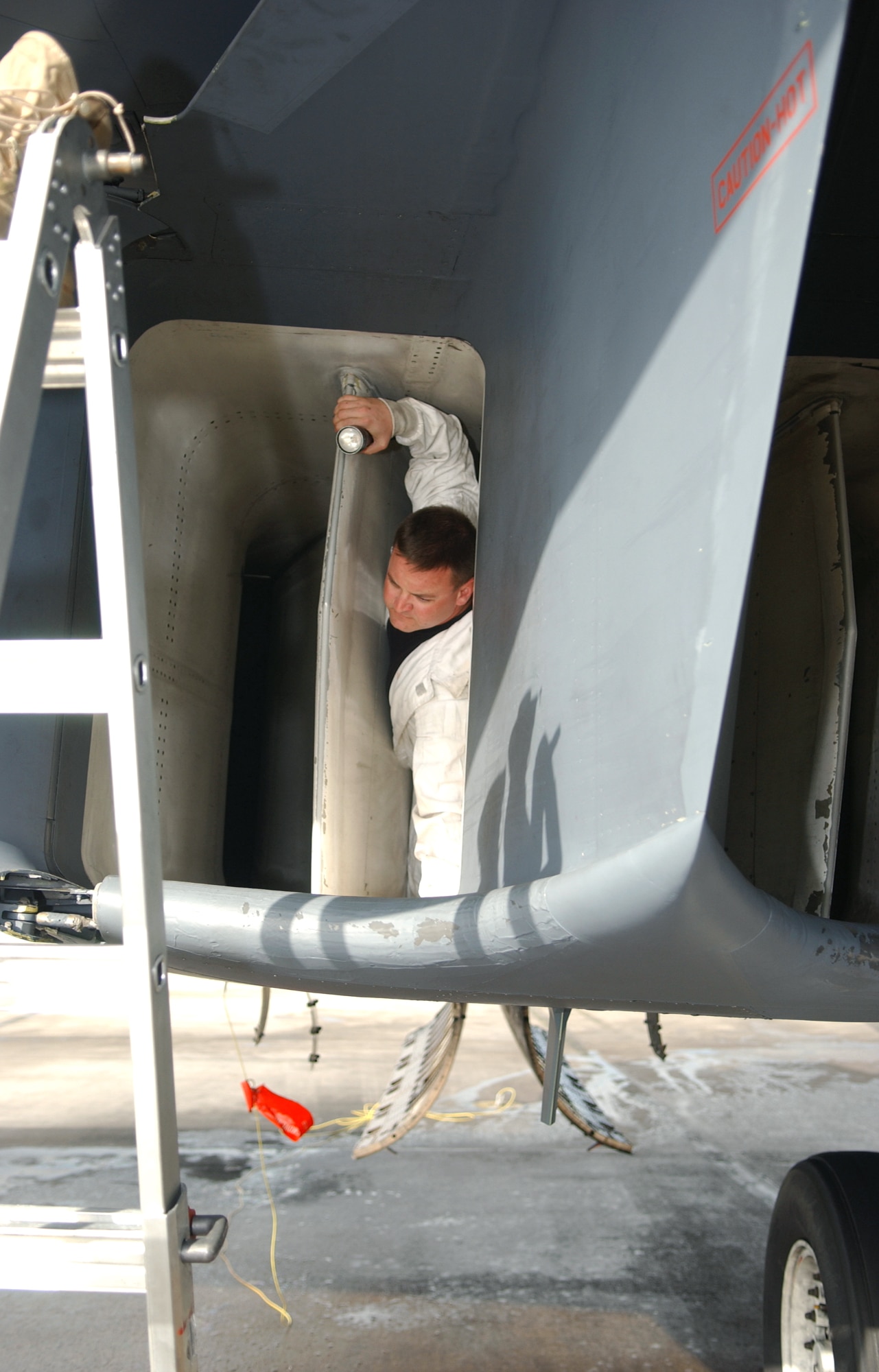 Staff Sgt. Dan Cowart, 40th Expeditionary Maintenance Squadron, exits a B1-B Lancer engine after performing a post-flight inlet inspection. (U.S. Air Force photo/Staff Sgt. Patrick Mitchell)