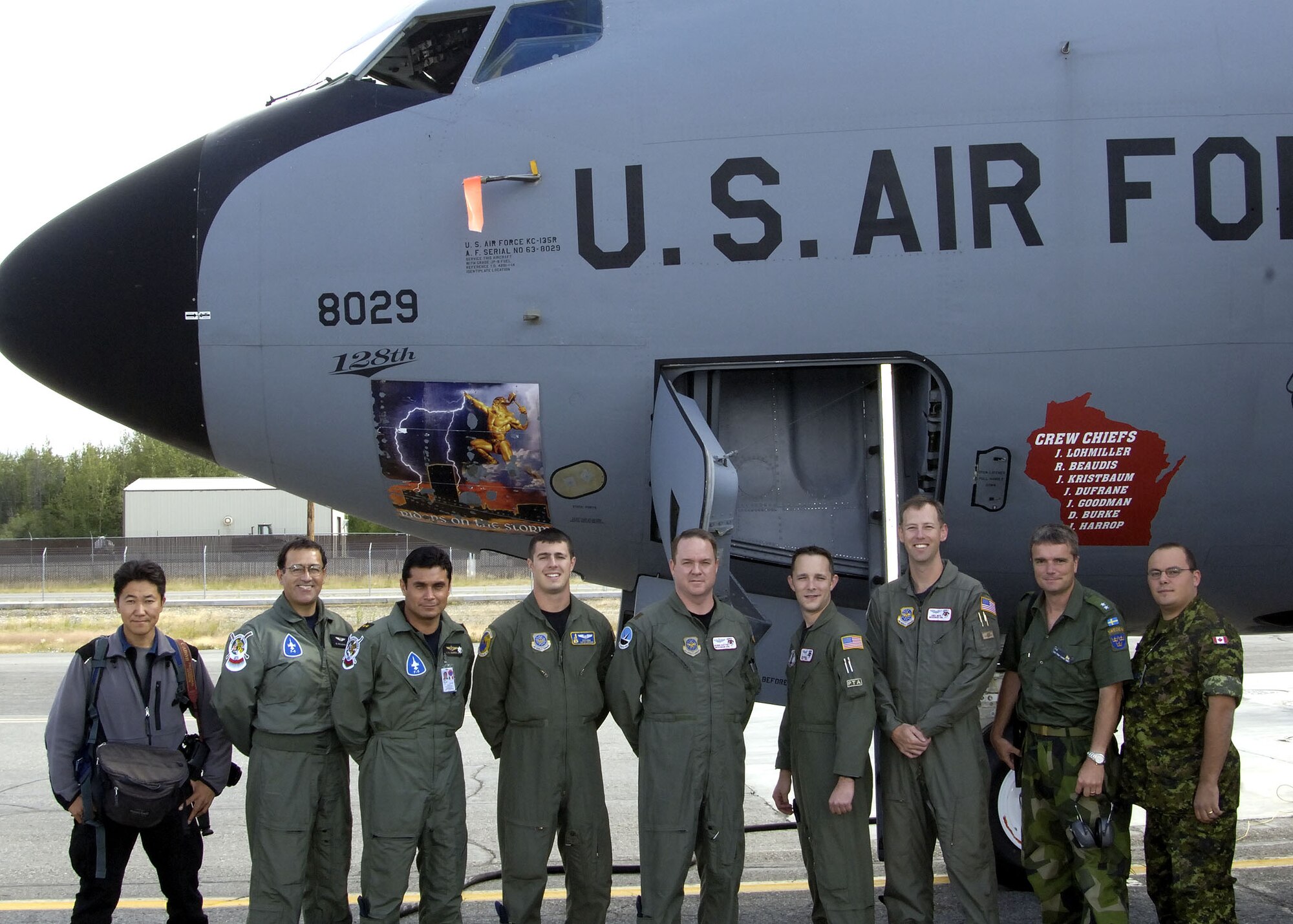 EIELSON AIR FORCE BASE, Alaska - Koji Nakano, Captain Gerard de Jesus Navarro Manon, Lieutenant Colonel Jose Antonio Sierra Amador, Tech Sergeant (TSgt) Keith Rownan, Major Shawn Gasney, Captain Andy Wahl, TSgt Chris Winchell First Lieutenant Peter Liander, and Corporal Jon Wilson after a familiarization flight at Excersise Cooperative Cope Thunder 06-3 (CCT06-3). Photo by Major Eric Hilliard, Excersise COOPERATIVE COPE THUNDER 06-3 Public Affairs

