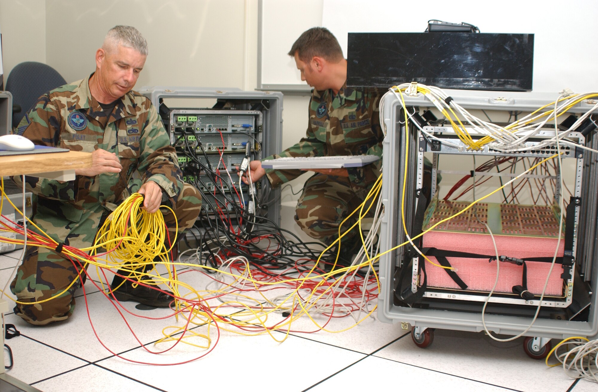 Master Sgt. Steve Foley, left, and Staff Sgt. Mike Harvell, 333rd Training Squadron mobile training team members, reconfigure and prepare mobile training kits to return to the field. (U.S. Air Force photo by Kemberly Groue)