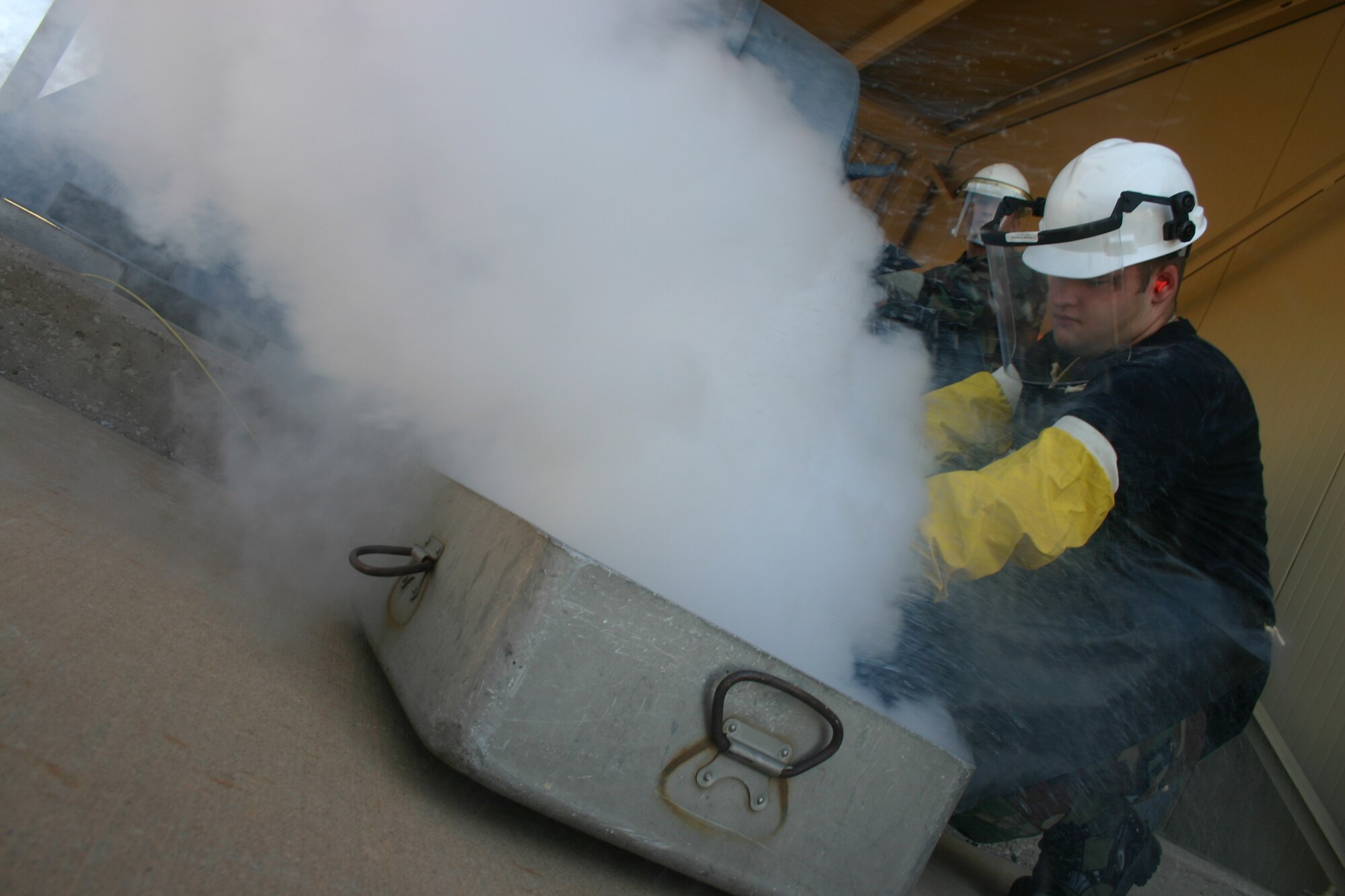 Senior Airman Richard Sharpe, a student from McGuire Air Force Base, N.J., purges a line from a liquid nitrogen tank as Staff Sgt. Richard Hill, a student from Barksdale AFB, La., controls the valves of the tank. Students use liquid nitrogen instead of liquid oxygen for safety purposes during training. (U.S. Air Force photo by John Ingle)