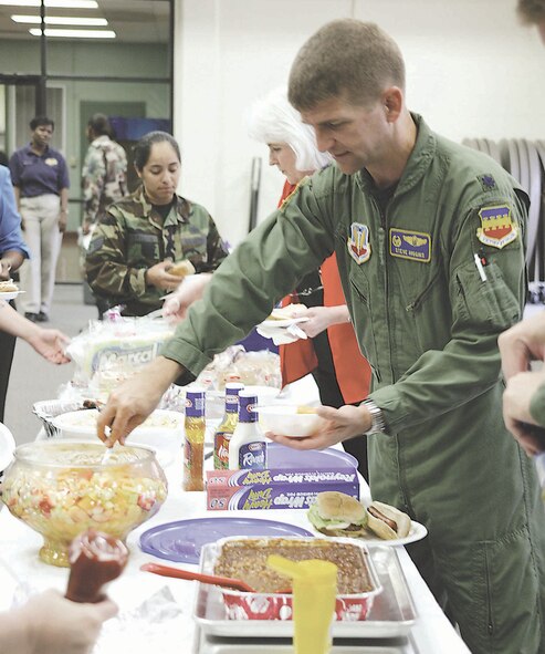 Lt. Col Stephen Higgins, Aerimedical Dental squadron commander, has come fruit salad at the community center July 21.  (U.S. Air Force photo/Senior Airman Holly MacDonald)