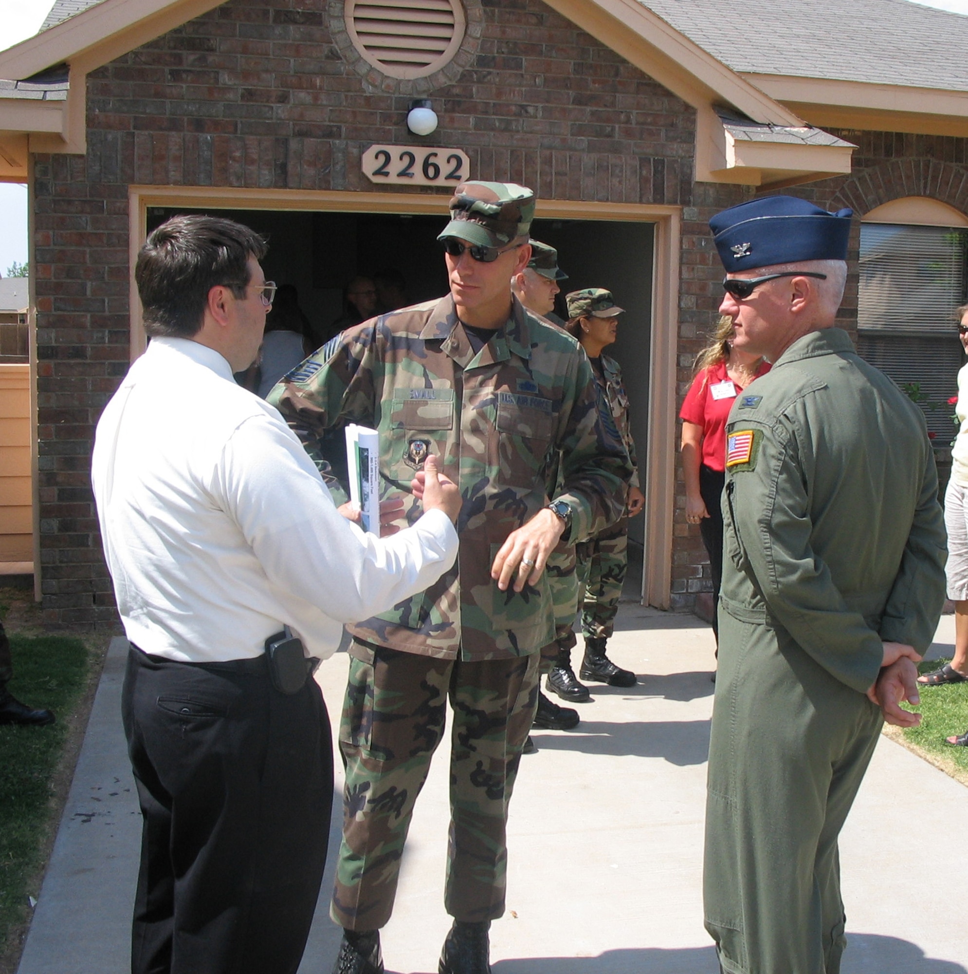 Tim Farmer (left), 27th Civil Engineering Squadron housing officer, discusses base housing with Chief Master Sgt. Todd Small, 16th Special Operations Wing command chief, and Col. Norman Brozenick Jr., 16th SOW commander, at the Cannon Meadows, housing subdivision in neighboring Portales, N.M., during the group's visit.  (U.S. Air Force Photograph by Lt. Amy Cooper)