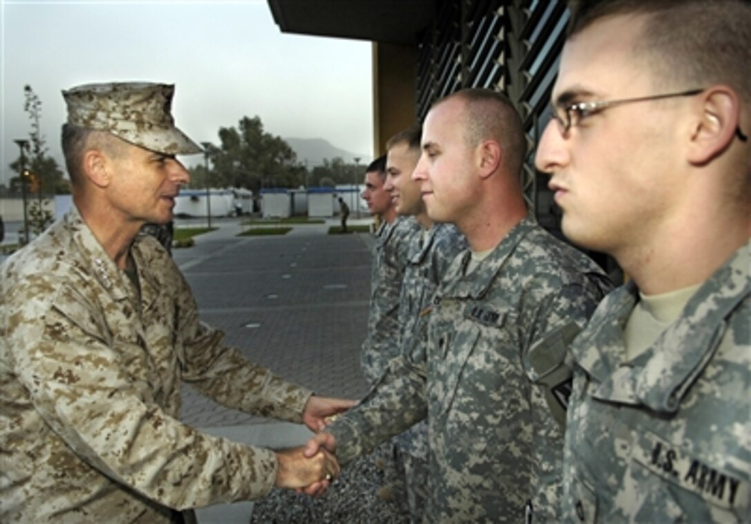 Chairman of the Joint Chiefs of Staff U.S. Marine Gen. Peter Pace greets and thanks soldiers for their service outside the American Embassy in Kabul, Afghanistan, July 27, 2006.
