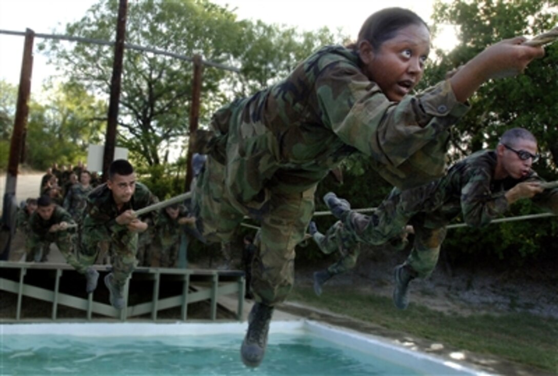 Air Force basic military trainees assigned to the 322nd Training Squadron at Lackland Air Force Base, Texas, run through a confidence-building course, July 25, 2006. They began their training June 27, 2006. 