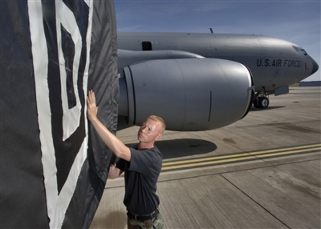 U.S. Air Force Staff Sgt. Craig Lambert checks an engine cover during a preflight inspection on one of the fanjets of a KC-135 Stratotanker aircraft at Royal Air Force Mildenhall, England, on July 24, 2006.  Lambert is attached to the 100th Aircraft Maintenance Squadron.  