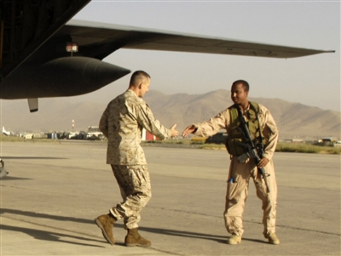 U.S. Marine General Peter Pace, center, chairman of the Joint Chiefs of Staff, shakes hands wiith a U.S. Air Force airman while visiting Kabul, Afghanistan, July 28, 2006.