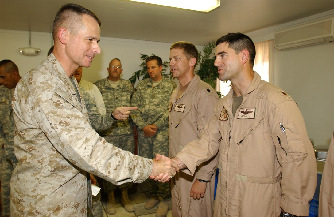Marine Gen. Peter Pace greets Navy Cmdr. Matt Mato, a pilot, during a visit to Bagram Air Base, Afghanistan, July 28. Pace answered questions and thanked the troops for their service. Photo by Staff Sgt. Robert R. Ramon, CFCA