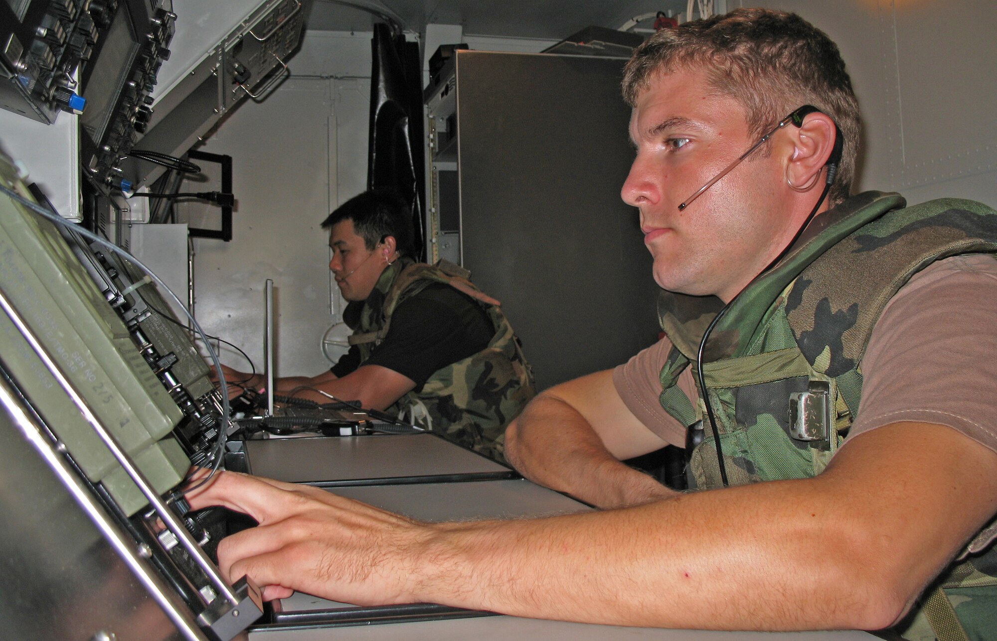 Tech. Sgts. Daniel Keefe and William Chang monitor radar screens during an exercise at Naval Station Barber's Point, Hawaii, on July 25. The Airmen are with the Hawaii Air National Guard's 297th Air Traffic Control Squadron. (U.S. Air Force photo/Tech. Sgt. Chris Vadnais)