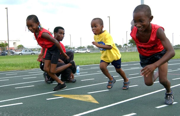 Coach Gary Evans coaches his daughter, 6-year-old Nadiria Evans (left), 5-year-old Trenton Growins (middle) and his 10-year-old son Tariq Evans in the 100-meter sprint. Since founding the nonprofit M-Town Track Club in 1992, 21 of the coach's athletes have received scholarships to schools such as the University of Alabama, Vanderbilt and Louisiana State University. (Courtesy photo)
