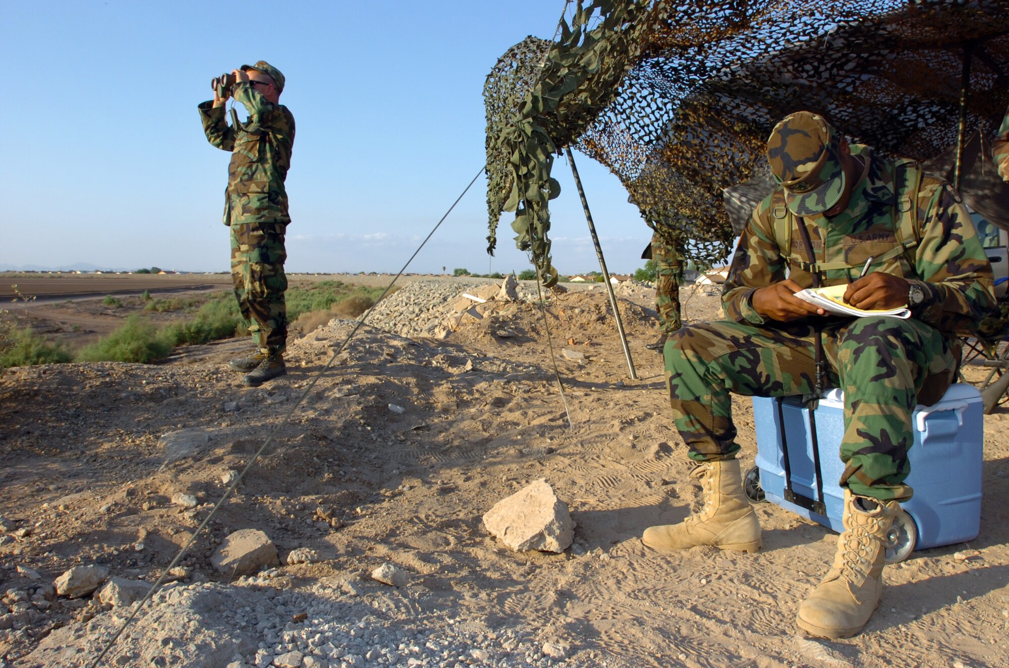 Army Cpl. Javin Morton draws a grid sketch of his site to improve his navigation at San Luis, Ariz., on July 30. Soldiers and Airmen from the North Carolina National Guard are deployed to Arizona in support of Operation Jump Start. Airmen are providing support for annual training by guardsmen who are working with U.S. Customs and Border Protection. (U.S. Air Force photo/Tech. Sgt. Brian E. Christiansen)

