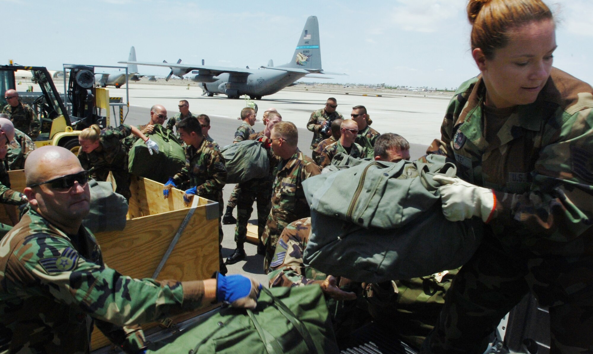 Tech. Sgt. Cindy Swazey helps load bags at Marine Corps Air Station Yuma, Ariz., on July 29. She is among the Airmen from the Kansas Air National Guard's 184th Air Refueling Wing deployed in support of Operation Jump Start. Airmen are providing support for annual training by guardsmen who are working with U.S. Customs and Border Protection. (U.S. Air Force photo/Tech. Sgt. Brian E. Christiansen)
