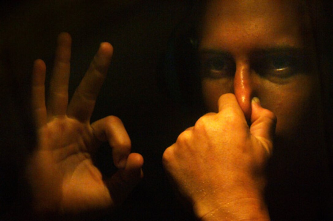 A U.S. Naval sea cadet gives the OK sign as he equalizes his eardrum