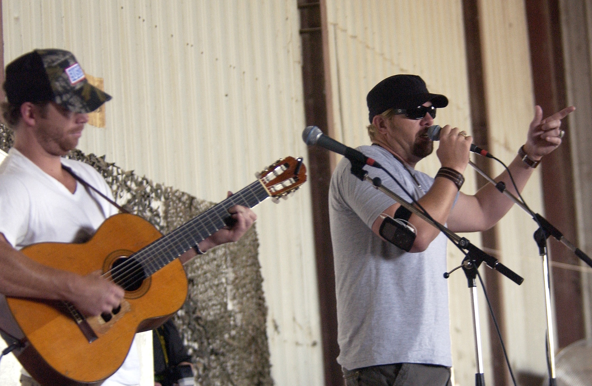 Country music performer Toby Keith and his songwriter Scotty Emerick perform for servicemembers at Forward Operating Base Warhorse, Iraq, on Saturday, May 27, 2006. The base in the Diyala Province was the first stop on Mr. Keith's USO tour. (U.S. Air Force photo/Tech. Sgt. Ken Bergmann)