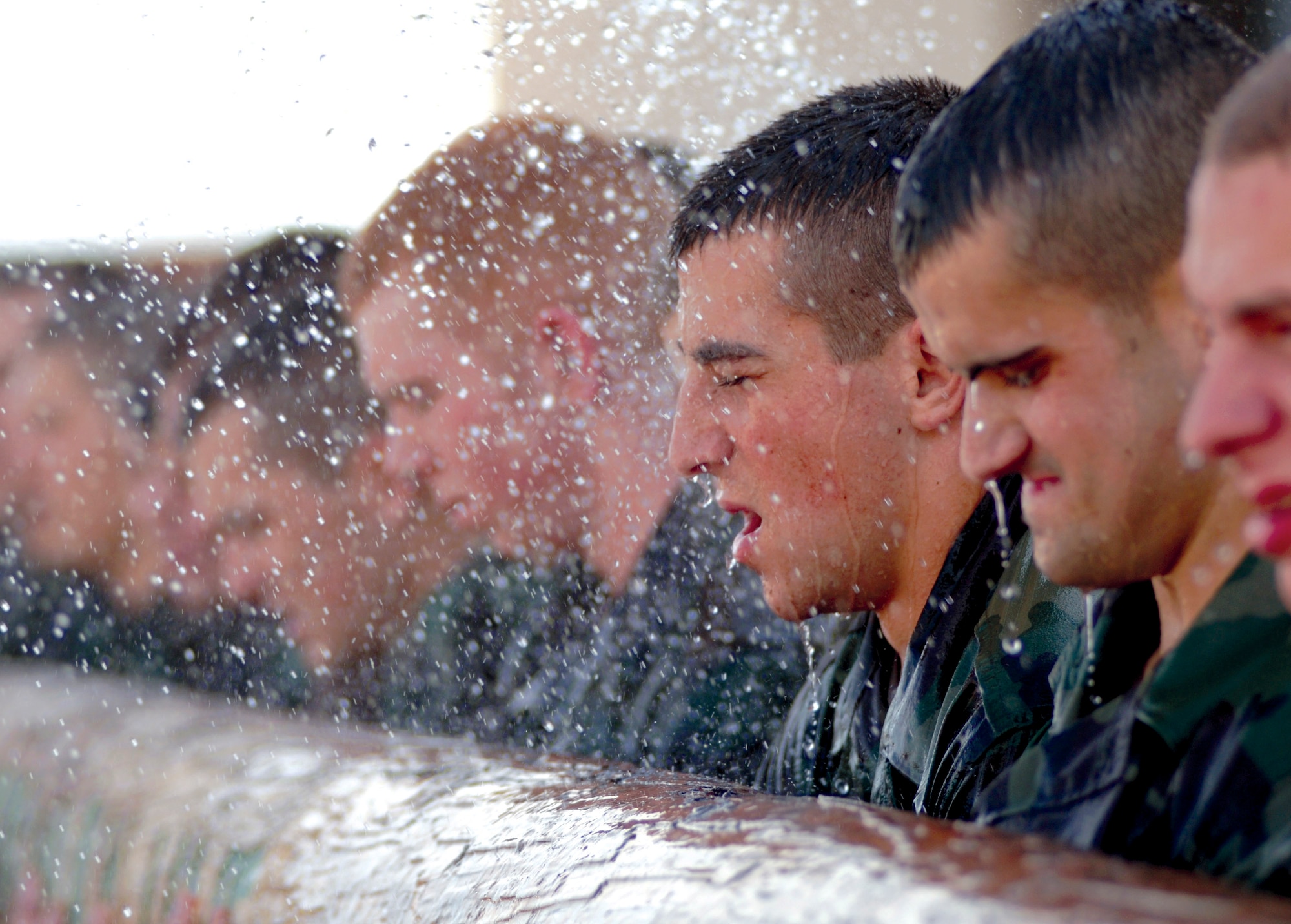Pararescue trainees get soaked by cadres as they try to follow orders and carry the painfully heavy training log during their extended training day at the Pararescue indoctrination training course at Lackland Air Force Base's Medina Annex, Texas.  PJ indoc is the first hurdle of intense physical and mental training for Pararescue trainees.  This course prepares them for the multitude of pipeline training they must endure to become US Air Force Pararescue members. (U.S. Air Force photo/Tech. Sgt Cecilio M. Ricardo Jr.)