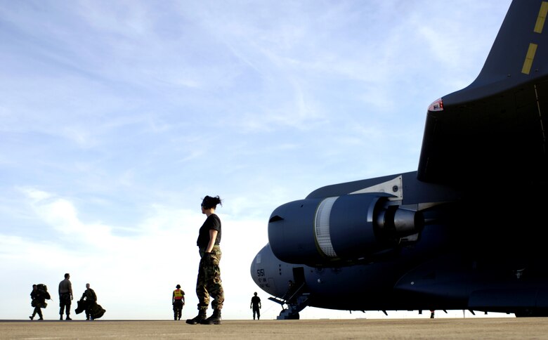 Staff Sgt. Liselle Bracey watches as Australian Defense Force members leave a C-17 Globemaster III at Darwin, Australia, on Thursday, June 1, 2006. Sergeant Bracey is with the 15th Logistics Readiness Squadron at Hickam Air Force Base, Hawaii. Two C-17s from Hickam are helping the Australian Defense Force reposition its forces to better support peace operations in East Timor. (U.S. Air Force photo/Tech. Sgt. Shane A. Cuomo) 
