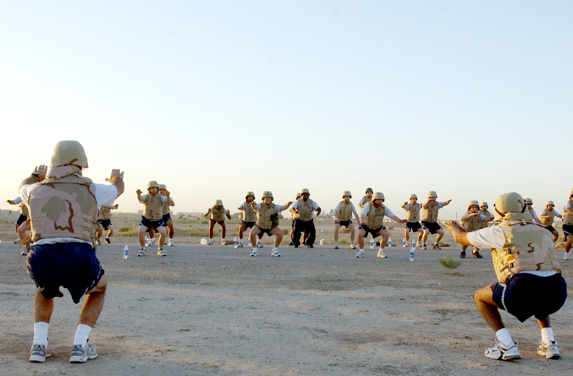 Airmen from the 407th Expeditionary Communications Squadron at Ali Base, Iraq, participate in a physical training session on Thursday, June 1, 2006, while wearing their flak vests and helmets. (U.S. Air Force photo/Staff Sgt. Jonathan Pomeroy)
